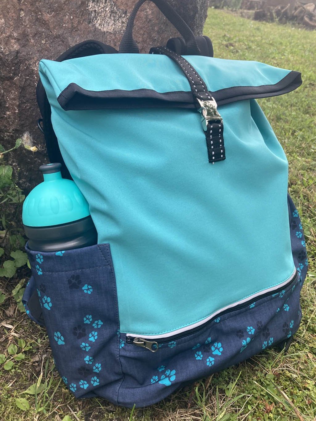 Bottle with turquoise paws