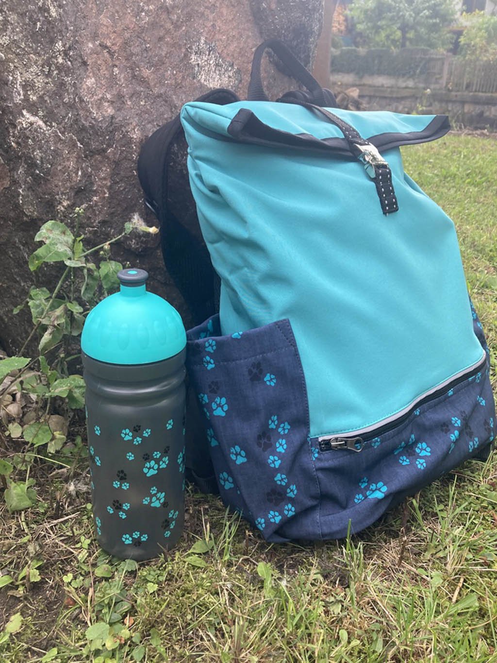 Bottle with turquoise paws