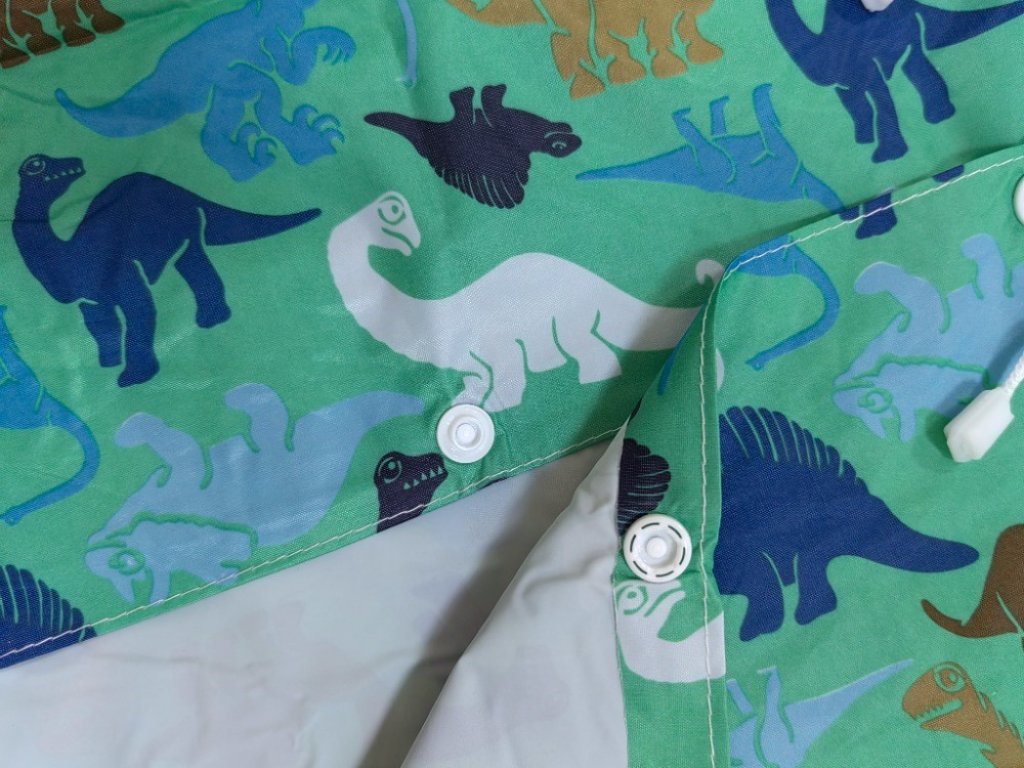 Dětská pláštěnka Dinosauři zelená